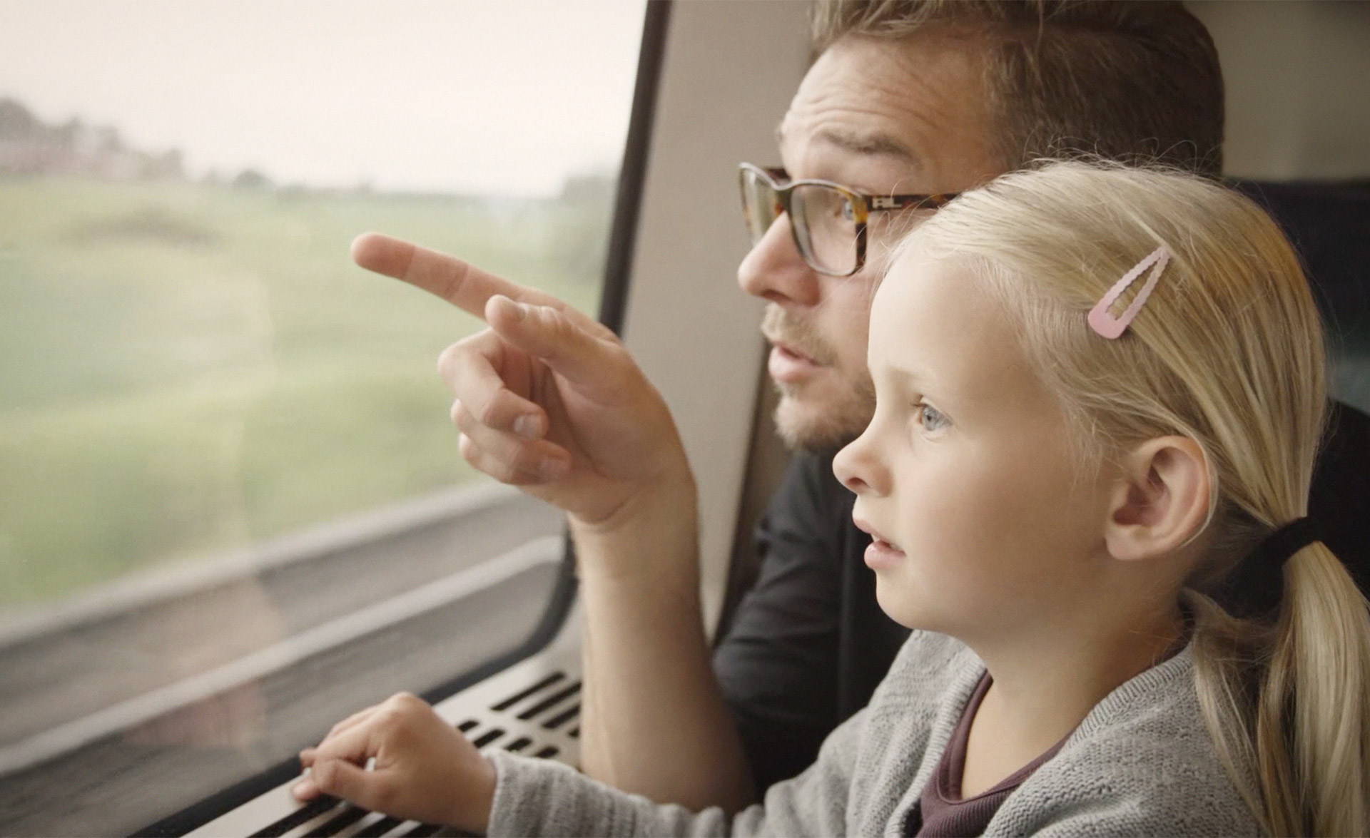 Father and daughter on a train in Sweden