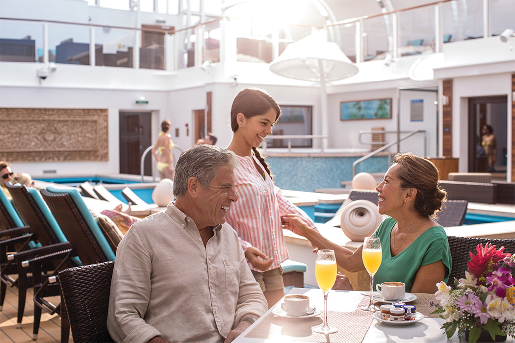 A family drinking coffee aboard a cruise ship