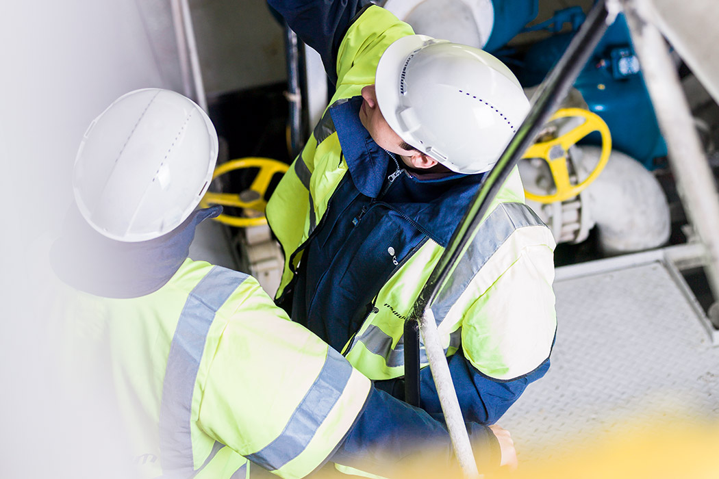 Two engineers at Consilium discussing the installation of a fire detector