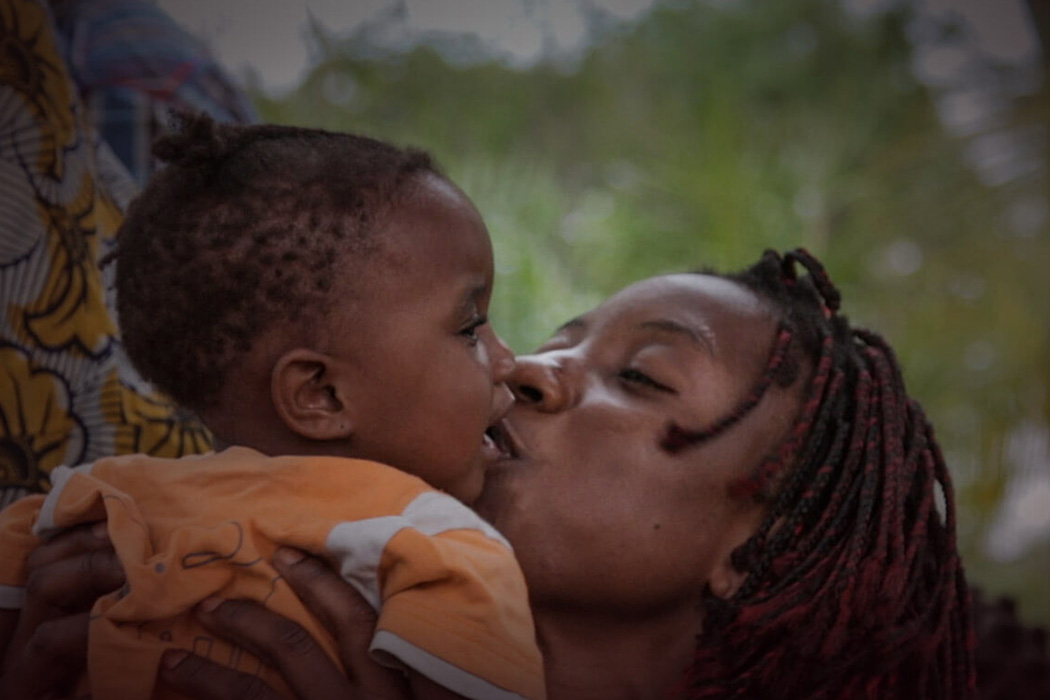 A mother and her child being helped by Mercy Ships