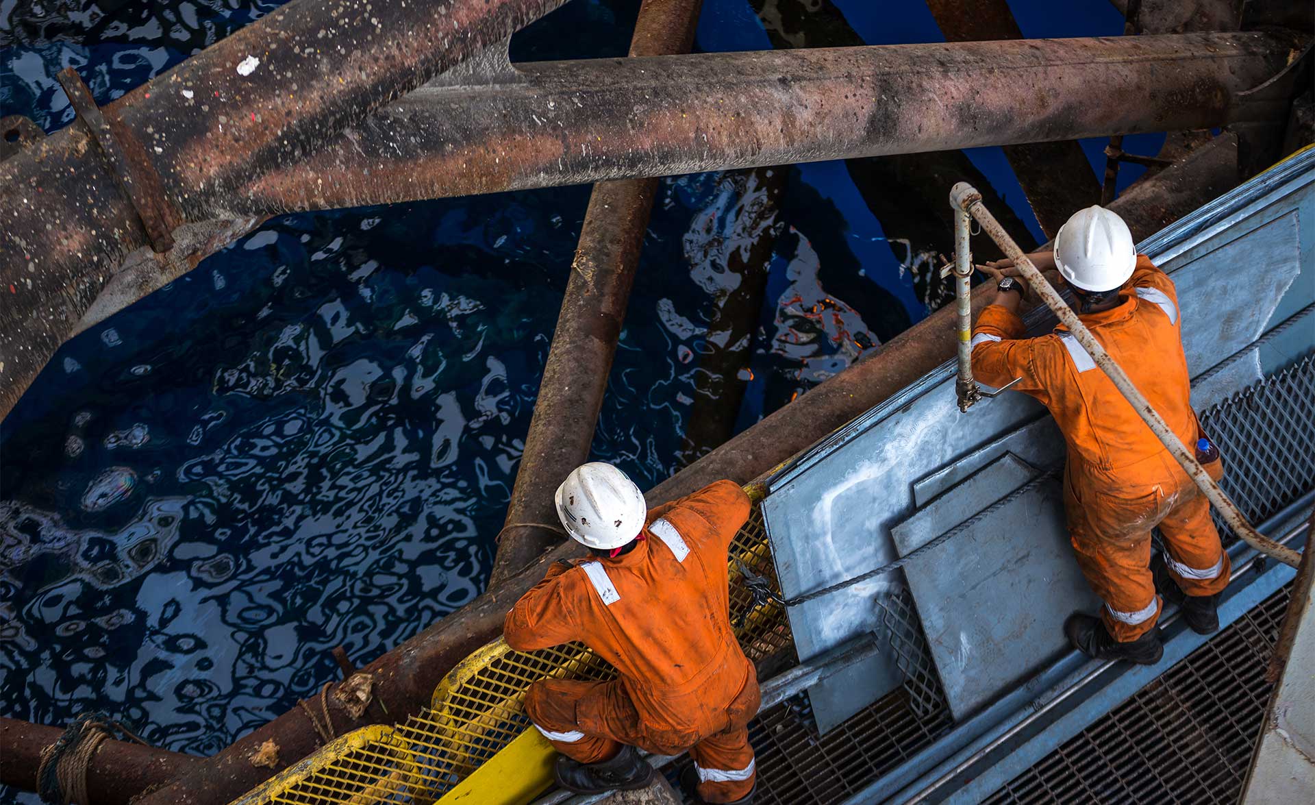 Workers on oil rig at sea