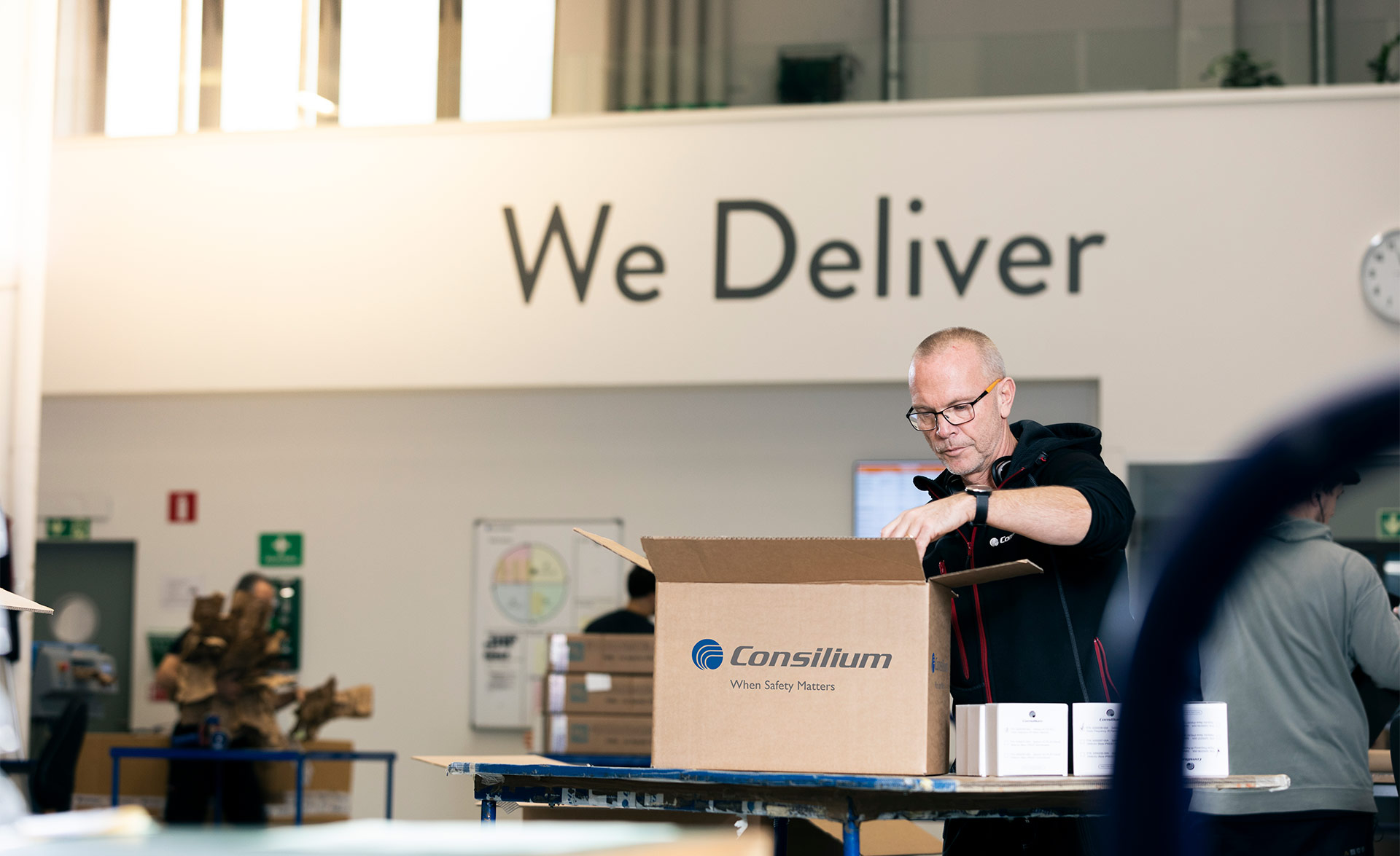 A warehouse worker at Consilium packs parts for fire detection