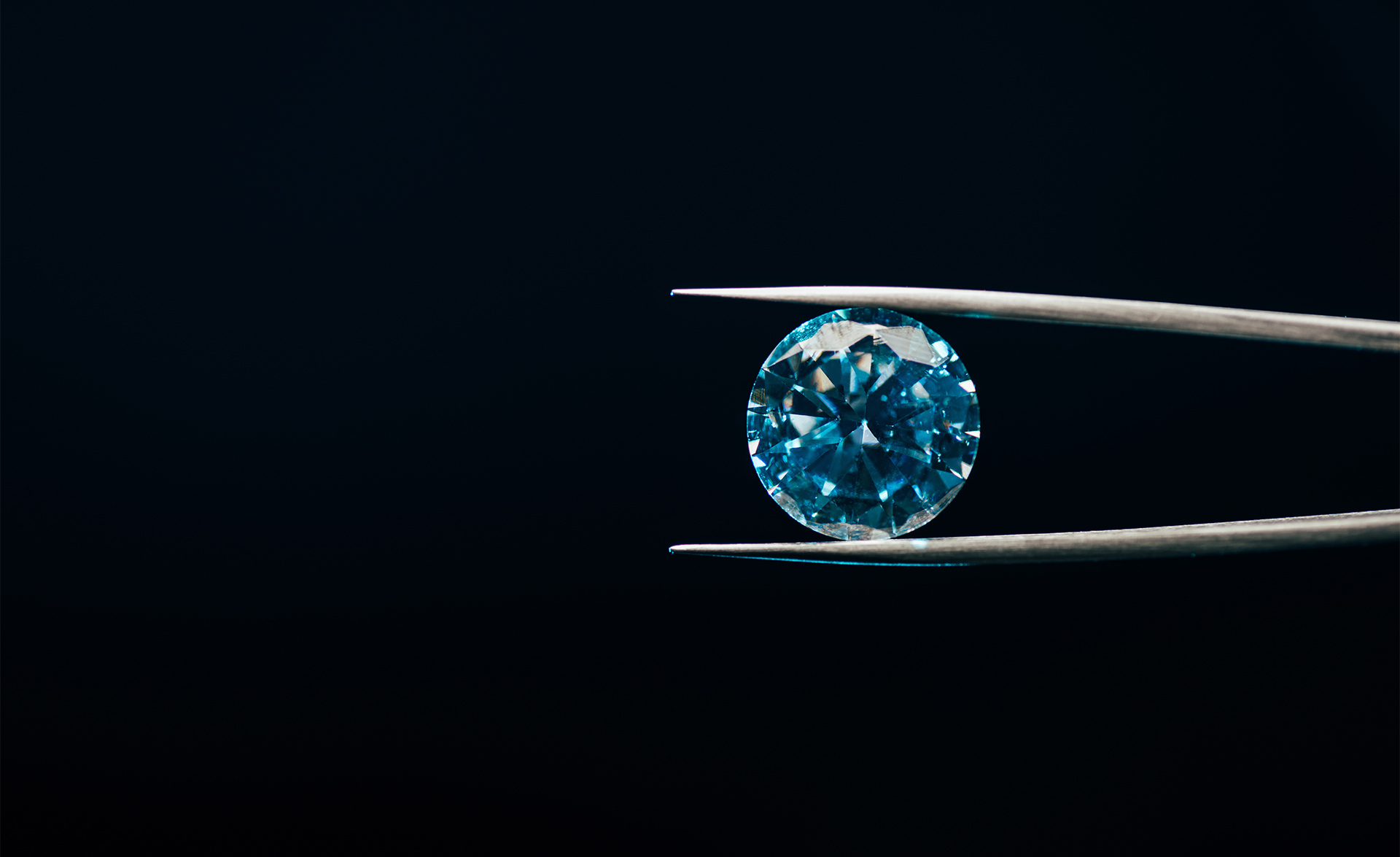 Tweezers that hold a diamond that symbolizes our loyalty program Red Carpet